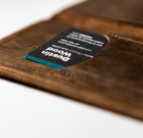 The inside front cover shows a business card in the holder