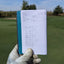 Holding up the first page of a filled-out golf log