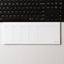 Weekly planner notepad on a desk in front of a keyboard