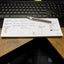 Filled out weekly planner notepad on a desk in front of a keyboard