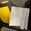 Open notebook with workout log next to a yellow and black medicine ball on a gym bench.